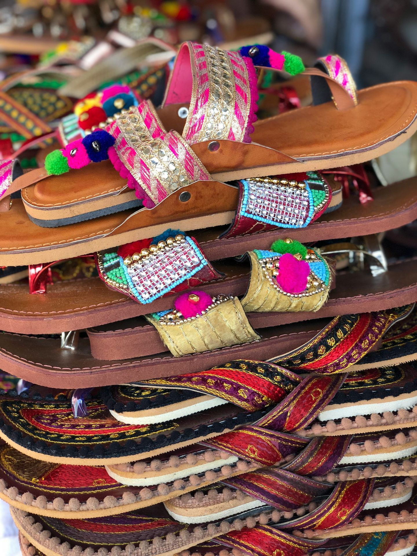 a pile of colorful sandals and sandals on display